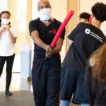 MMA teacher training kids with foam sword