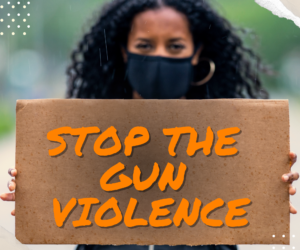 Gun Violence Prevention Program Photo Woman holding up sign saying stop the gun violence