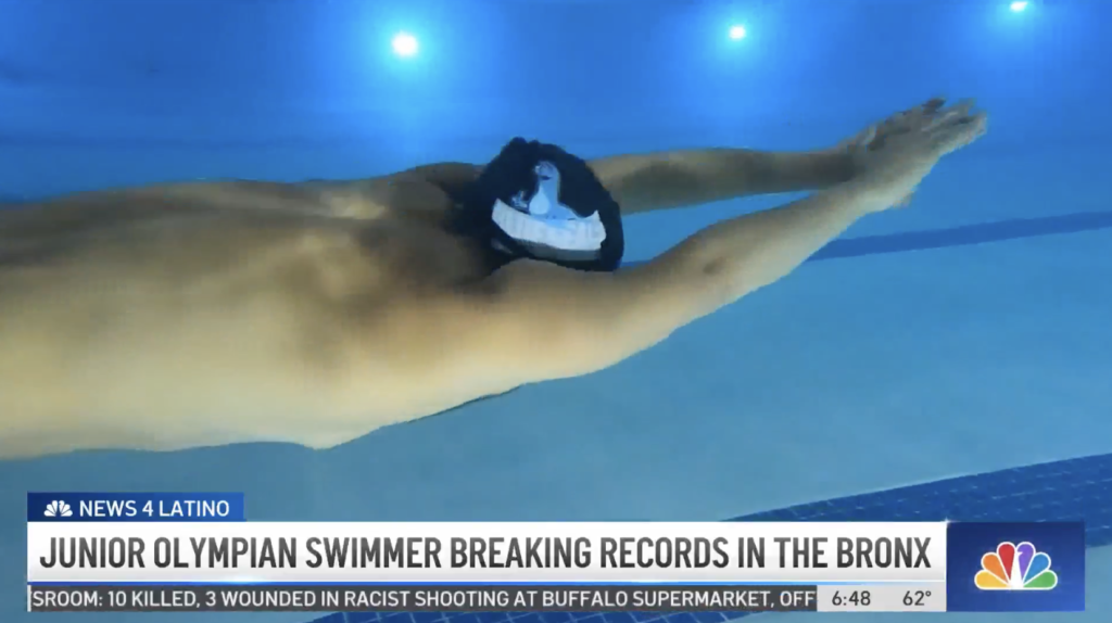 Male swimmer glides under the water.