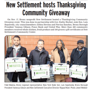NY politicians and New Settlement Executive Director hold food boxes during a Thanksgiving giveaway