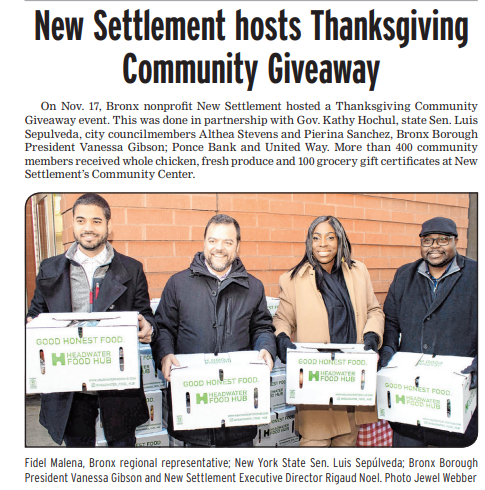NY politicians and New Settlement Executive Director hold food boxes during a Thanksgiving giveaway