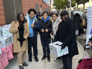 Vanessa L Gibson, Rigaud Noel, and other volunteers at the Thanksgiving Food Pantry