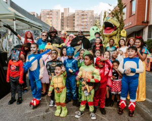 kids in Halloween costumes standing on a city street