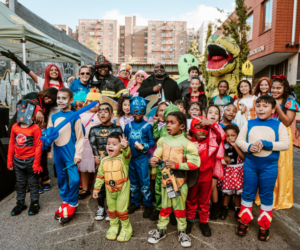 kids in Halloween costumes standing on a city street